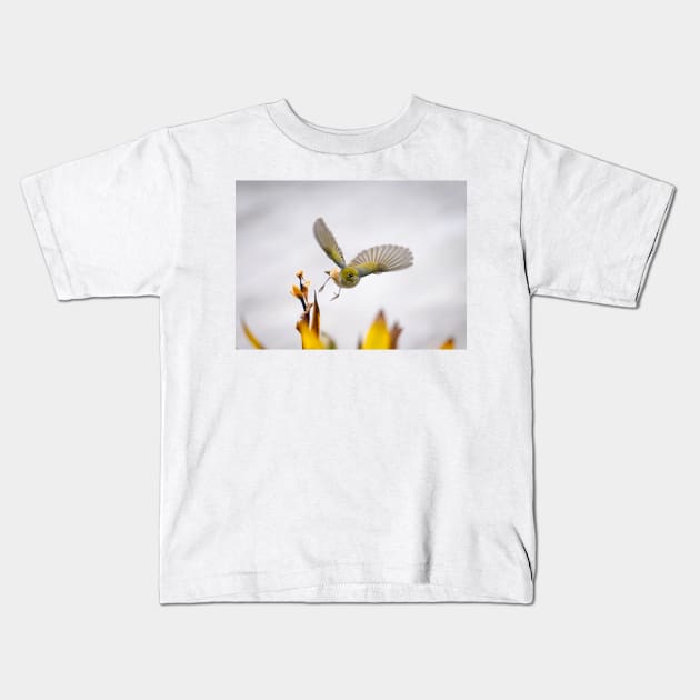 Waxeye in  flight above flowers just feeding on. Kids T-Shirt by brians101